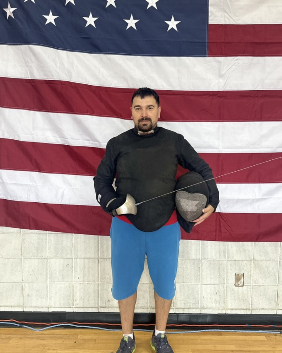 Giannis Notaras in fencing kit with sabre and mask
